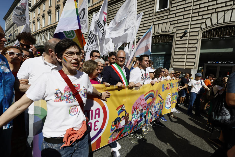 Rome Mayor Roberto Gualtieri, wearing the three color band of the Italian flag, joins the LGBTQ+ Pride parade in Rome, Saturday, June 10, 2023. Rome's annual LGBTQ+ Pride parade is winding its way through the Italian capital. This year's version provides a counterpoint to the right-wing national government's crackdown on surrogate pregnancies. Earlier this year, the government headed by far-right Premier Giorgia Meloni told municipal officials to refrain from recording both members of a same-sex couple as the parent of the child, only the biological parent. Among those who have defied that order was center-left Rome Mayor Roberto Gualtieri, who came to Saturday's parade. (Cecilia Fabiano/LaPresse via AP)