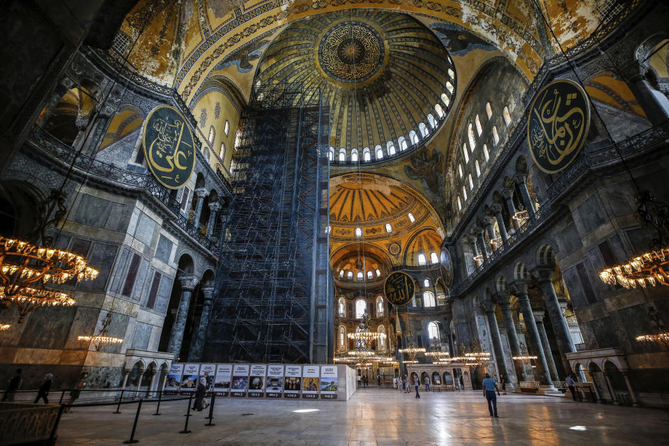 People visit the Byzantine-era Hagia Sophia, one of Istanbul's main tourist attractions in the historic Sultanahmet district of Istanbul on Thursday, June 25, 2020. The 6th-century building is now at the center of a heated debate between conservative groups who want it to be reconverted into a mosque and those who believe the World Heritage site should remain a museum. (AP Photo/Emrah Gurel)