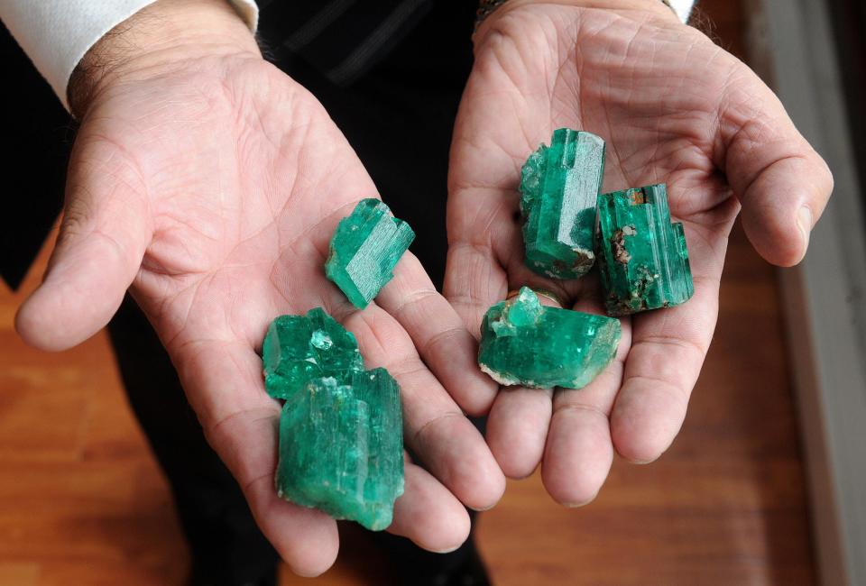 A man shows a couple of Colombian raw emeralds exhibited at the International Emerald Museum in Bogota on October 22, 2008.