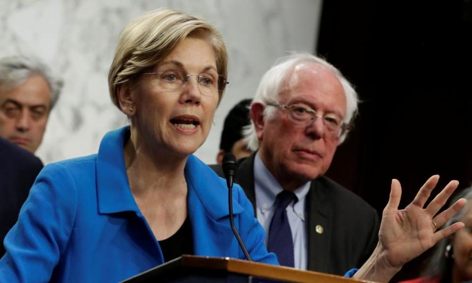 Senator Elizabeth Warren, with Bernie Sanders, speaks on Capitol Hill.