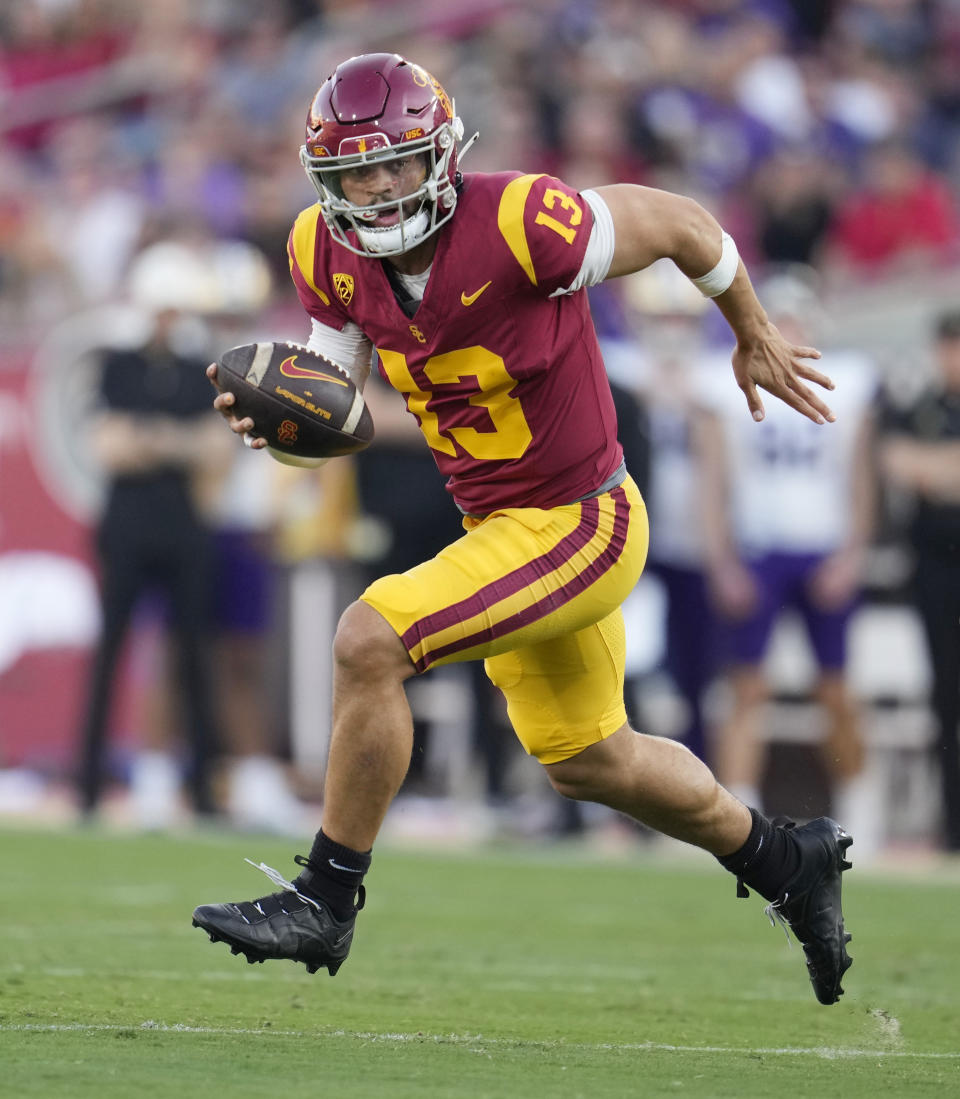 FILE - Southern California quarterback Caleb Williams (13) runs during the first half of an NCAA college football game against Washington Saturday, Nov. 4, 2023, in Los Angeles. Williams is expected to be taken in the first round of the NFL Draft. (AP Photo/Marcio Jose Sanchez, File)