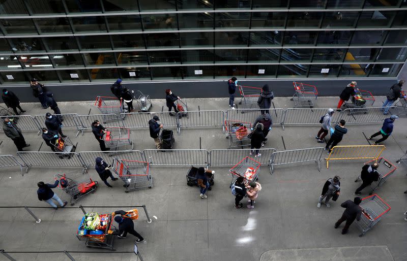 FILE PHOTO: Shoppers practice social distancing as they wait to enter Target store during the outbreak of coronavirus disease (COVID-19) in New York