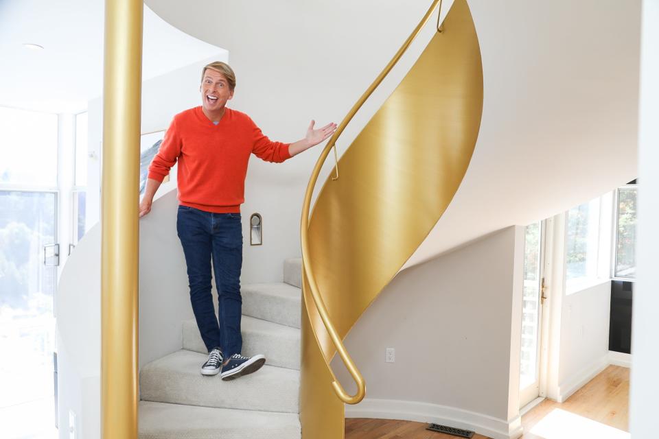 Jack McBrayer next to a gold staircase in "Zillow Gone Wild"