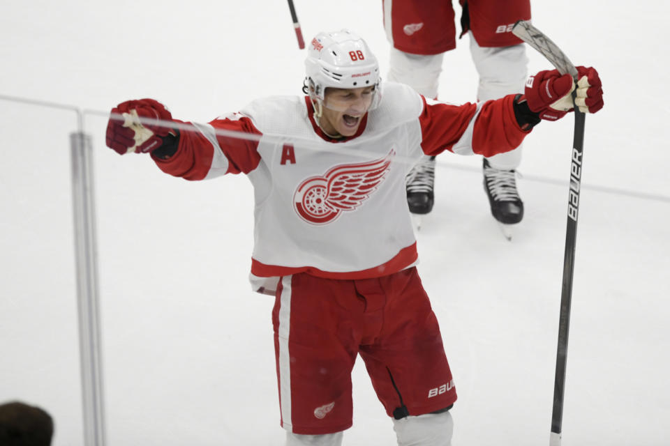 Detroit Red Wings' Patrick Kane (88) celebrates after scoring the winning goal against Chicago Blackhawks goalie Petr Mrazek (34) to win 3-2 in overtime in an NHL hockey game, Sunday, Feb. 25, 2024, in Chicago. (AP Photo/Paul Beaty)