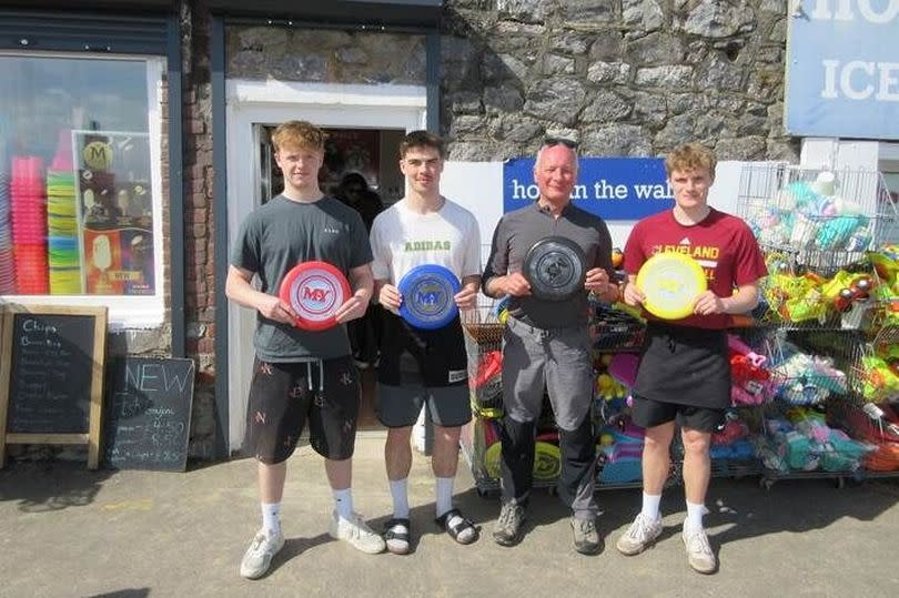 Shop staff holding frisbees