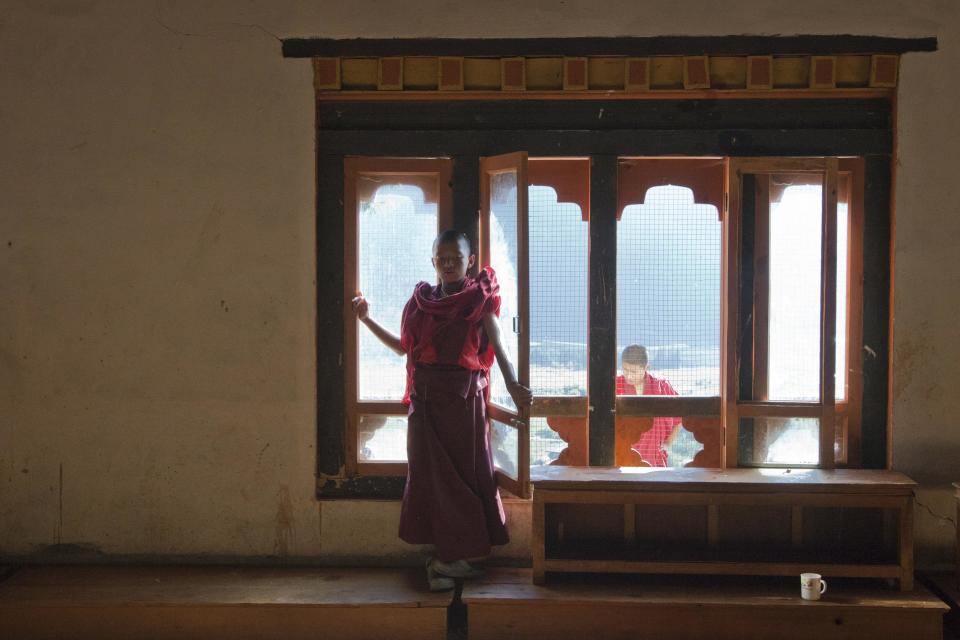 A novice monk is framed by a window at the Dechen Phrodrang Buddhist monastery in Bhutan's capital Thimphu