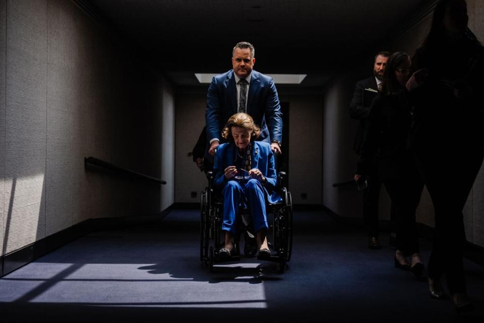 Sen. Dianne Feinstein is pushed in a wheelchair to attend a Senate Judiciary Committee hearing in Washington in May.