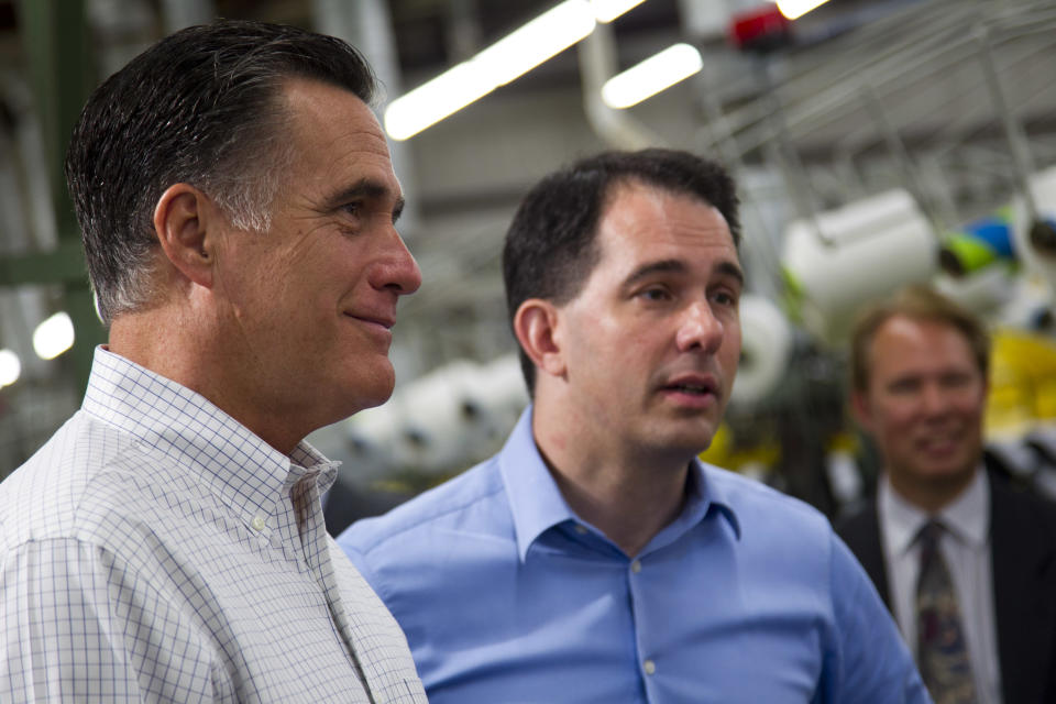 Republican presidential candidate, former Massachusetts Gov. Mitt Romney, left, stands with Gov. Scott Walker, R-Wis., during a campaign stop at Monterey Mills on Monday, June 18, 2012 in Janesville, Wis. (AP Photo/Evan Vucci)