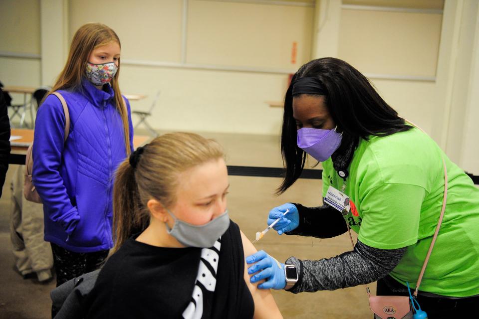 Brooke Kraus, of Knoxville, receives her vaccination from Brittonya Sparks, a nurse with New Direction Health Care Solutions, during a COVID-19 vaccine clinic at the Jacob Building at Chilhowee Park in Knoxville, Tenn. on Friday, Jan. 7, 2022. The clinic offered vaccines for children and adults alike as well as activities and information booths from community organizations. The clinic will be open 10 a.m.-3 p.m. on Saturday.