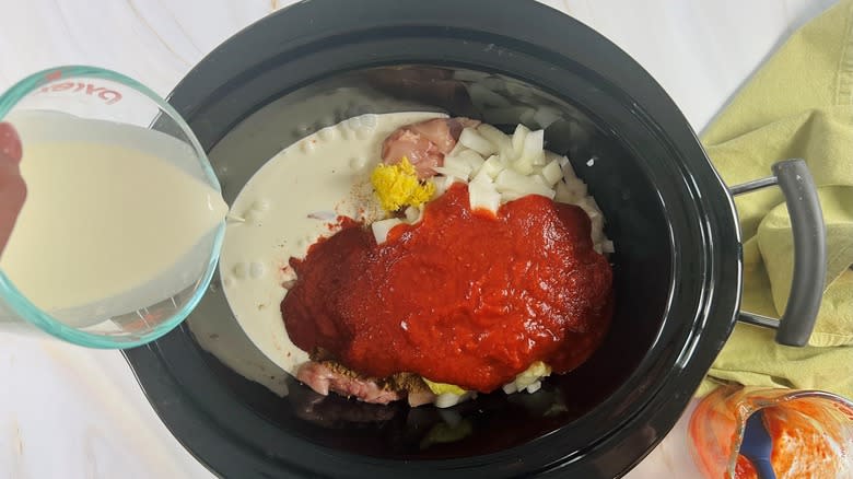 pouring cream into slow cooker