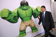 LONDON, ENGLAND - JANUARY 24: A man walks past an advertisement for a Lego "Hulk" character at the 2012 London Toy Fair at Olympia Exhibition Centre on January 24, 2012 in London, England. The annual fair, which is organised by the British Toy and Hobby Association, brings together toy manufacturers with retailers from around the world. (Photo by Oli Scarff/Getty Images)