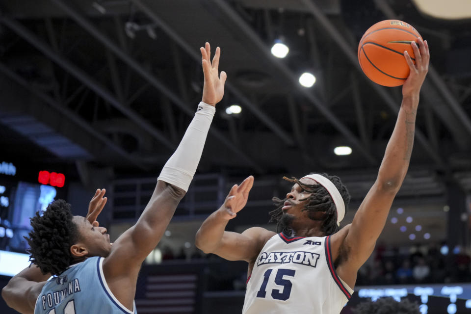 Dayton forward DaRon Holmes II, right, shoots against Rhode Island center Jeremy Foumena during the first half of an NCAA college basketball game, Saturday, Jan. 20, 2024, in Dayton, Ohio. (AP Photo/Aaron Doster)