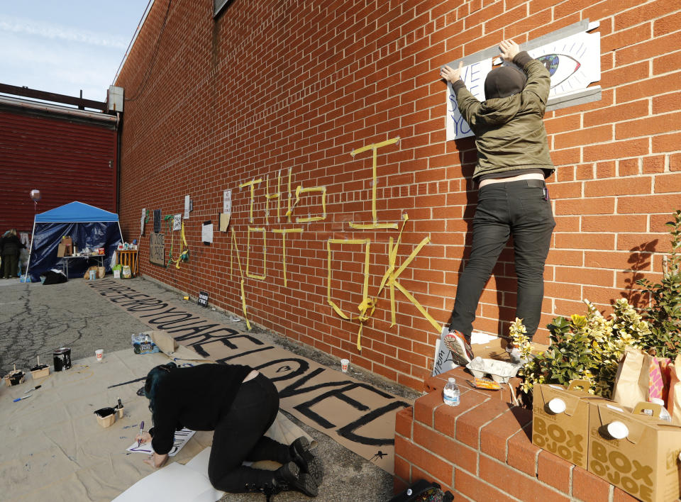 People post and make signs outside the Metropolitan Detention Center, Sunday, Feb. 3, 2019, in New York, where prisoners haven't had access to heat, hot water, electricity, or proper sanitation since earlier in the week, including throughout the recent frigid weather, in New York. (AP Photo/Kathy Willens)