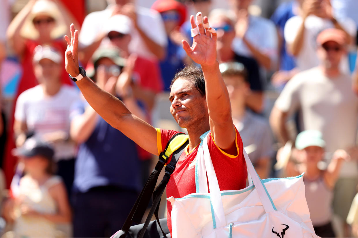 PARIS, FRANCE - JULY 29:  Rafael Nadal of Team Spain acknowledges the crowd after losing to Novak Djokovic of Team Serbia at the end of their the Men's Singles second round match on day three of the Olympic Games Paris 2024 at Roland Garros on July 29, 2024 in Paris, France. (Photo by Clive Brunskill/Getty Images)