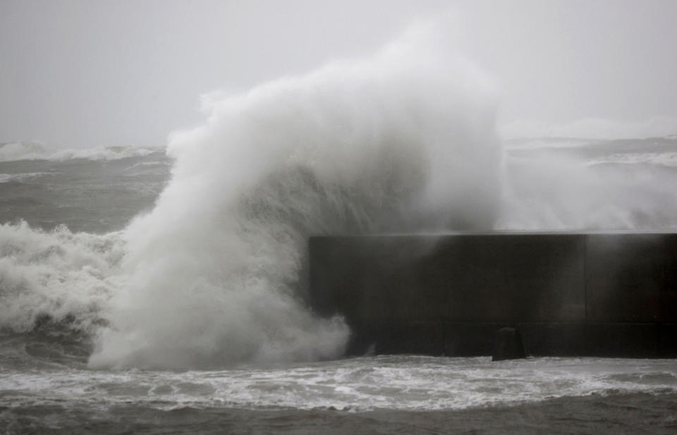 High waves hit the shore in Miyazaki, southern Japan, Sunday, Sept. 18, 2022, as a powerful typhoon approaching southern Japan on Sunday lashed the region with strong winds and heavy rain.(Kyodo News via AP)