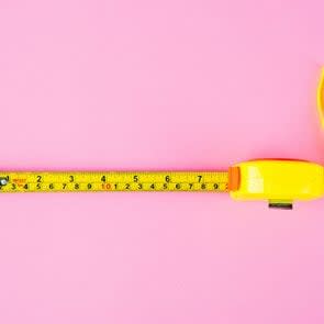 Measuring Tape on pink background