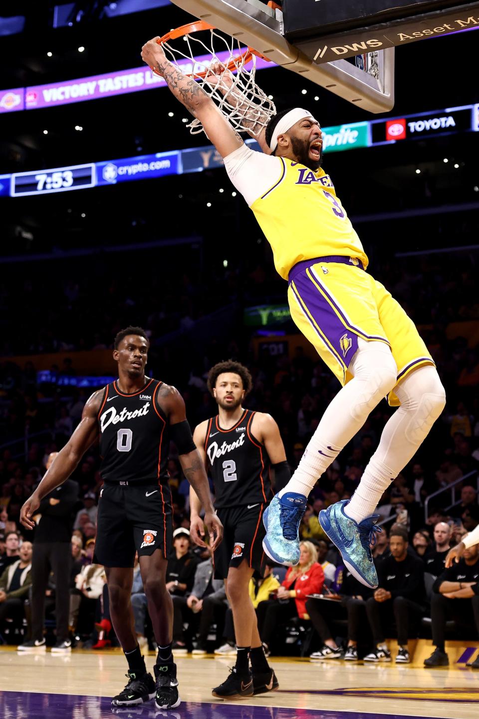 Lakers center Anthony Davis dunks the ball against Pistons center Jalen Duren, left, and Cade Cunningham during the first quarter on Tuesday, Feb. 13, 2024, in Los Angeles.