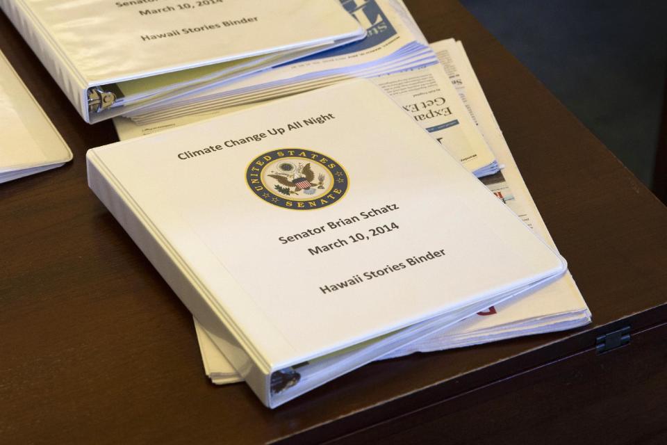 A binder containing climate change talking points and information for Sen. Brian Schatz, D-Hawaii, sits on a desk before a meeting of the Senate Climate Action Task Force prior to taking to the Senate Floor all night to urge action on climate change on Monday, March 10, 2014, in Washington. (AP Photo/ Evan Vucci)