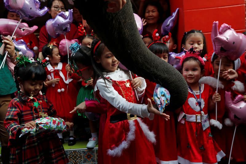 An elephant distributes Christmas presents to students at a school in Ayutthaya