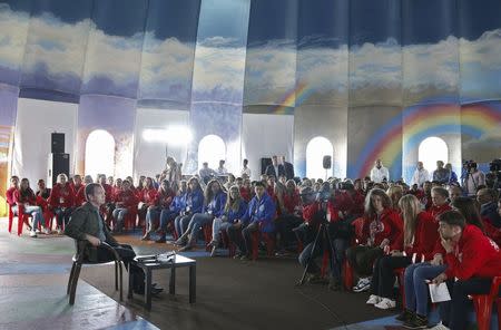 Russia's Prime Minister Dmitry Medvedev (L) attends the all-Russian youth educational forum "Iturup" in Kurilsk during his visit to Iturup Island, one of four islands known as the Southern Kurils in Russia and the Northern Territories in Japan, August 22, 2015. REUTERS/Dmitry Astakhov/RIA Novosti/Pool