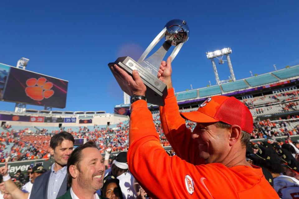 Dec 29, 2023; Jacksonville, FL, USA; Clemson Tigers head coach Dabo Swinney is presented with the Gator Bowl trophy after beating the Kentucky Wildcats at EverBank Stadium.