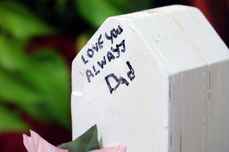 Crosses commemorating the lives of the five people killed in the Henry Pratt shooting.