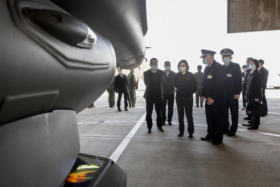 In this photo released by the Taiwan Presidential Office, Taiwan's President Tsai Ing-wen, center, accompanied by officials, looks at the F-16 fighter jet at a military base in Chiayi, southwestern Taiwan, Friday, Jan. 6, 2023. President Tsai visited a military base Friday to observe drills while rival China protested the passage of a U.S. Navy destroyer through the Taiwan Strait, as tensions between the sides showed no sign of abating in the new year. (Taiwan Presidential Office via AP)