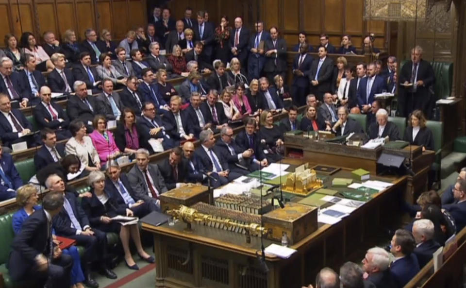 In this grab taken from video, Britain's Prime Minister Theresa May is congratulated by a Conservative MP at the conclusion of the debate ahead of a vote on her Brexit deal in the House of Commons, London, Tuesday Jan. 15, 2019. British lawmakers have begun voting on whether to approve or reject the divorce agreement between the government and the European Union. (House of Commons/PA via AP)