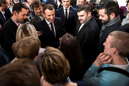 French President Emmanuel Macron (C) speaks with guests next to Minister of the Ecological and Social Transition Nicolas Hulot (on his L) and French President of the Young Farmers Association Jeremy Decerle (on his R) after he delivered a speech to the young French farmers invited at the Elysee Palace before the opening of the 2018 Paris International Agricultural Show in Paris, France, February 22, 2018. REUTERS/Etienne Laurent/Pool