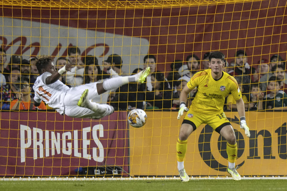 Toronto FC forward Latif Blessing, left, attempts a shot against FC Cincinnati goalkeeper Roman Celentano during the first of an MLS soccer game in Toronto, Saturday, Sept. 30, 2023. (Chris Young/The Canadian Press via AP)