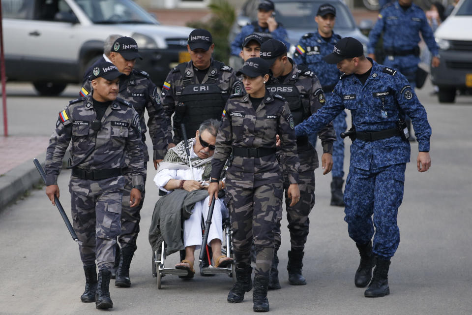 In this Friday, May 17, 2019 photo, former FARC rebel leader Seuxis Hernandez, known by his alias Jesus Santrich, leaves La Picota jail escorted by prison guards in Bogota, Colombia. Santrich was recaptured and taken back into custody by authorities as soon as he was released from jail. (AP Photo/Fernando Vergara)