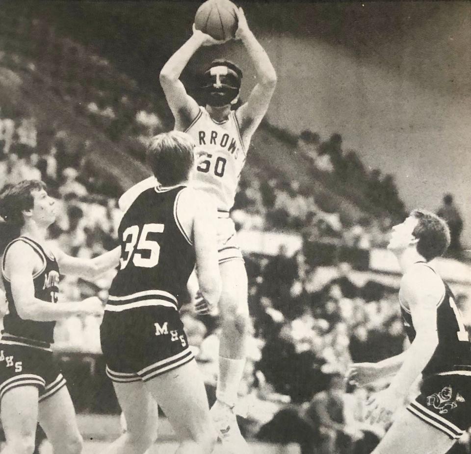 Watertown's John Decker, wearing a wrestling mask to protect an injured nose, shoots over Mitchell defenders Dean Jacobsen (left), Bart Friedrick (35) and Tim Byrd during a 1985 high school boys basketball game in the Watertown Civic Arena. Decker is now the principal at Jefferson Elementary School in Watertown.