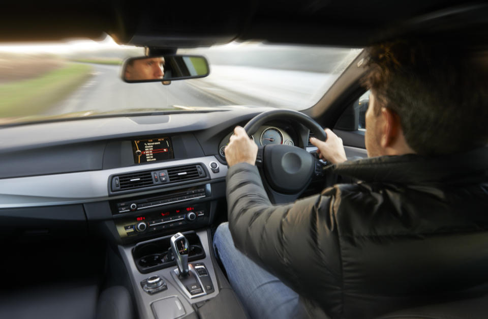 A person sitting in a right-side driver's seat