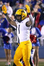 West Virginia wide receiver Winston Wright Jr. celebrates a touchdown during the second quarter of an NCAA college football against the Kansas game Saturday, Nov. 27, 2021, in Lawrence, Kan. (AP Photo/Ed Zurga)