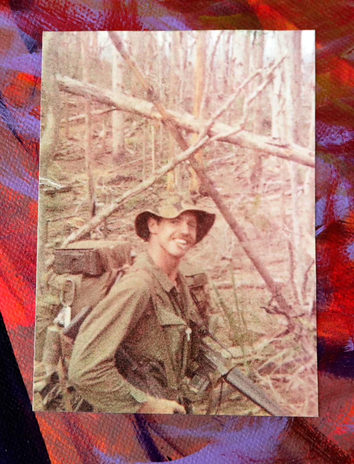 A photo of Darryl Johnson during his service in the Vietnam War on a piece of artwork that he created in therapy to help work through post-traumatic stress disorder.