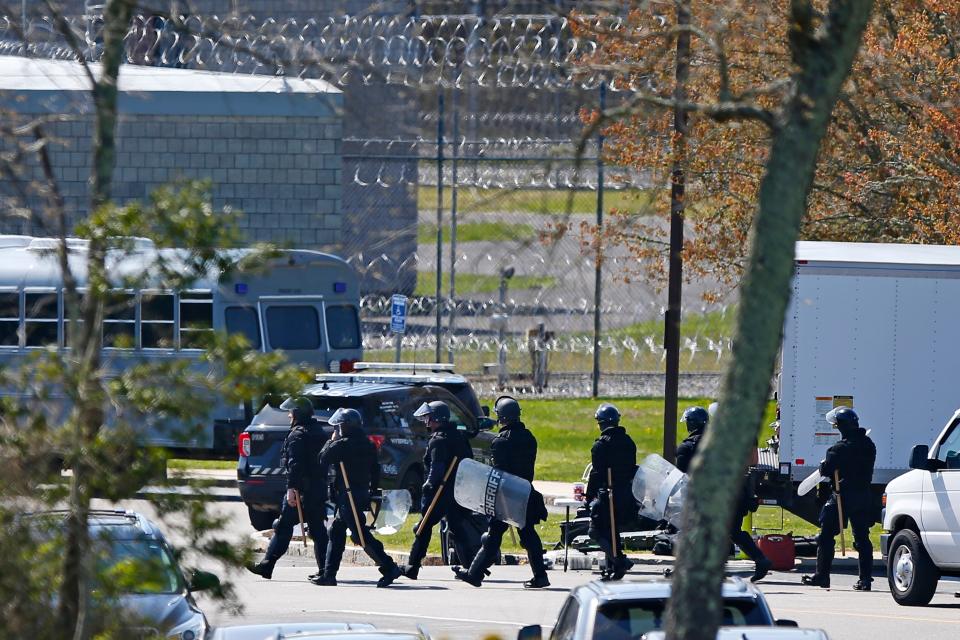 SWAT team members move toward the entrance of the Bristol County House of Correction in Dartmouth where a disturbance occurred.