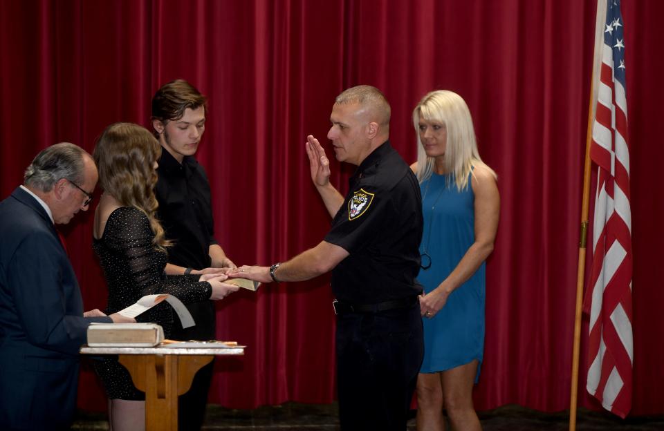 Donald Wensel, a detective lieutenant, was promoted to captain with the Alliance Police Department on Wednesday, Nov. 29, 2023, during a ceremony at Firehouse Theatre as his family looks on.