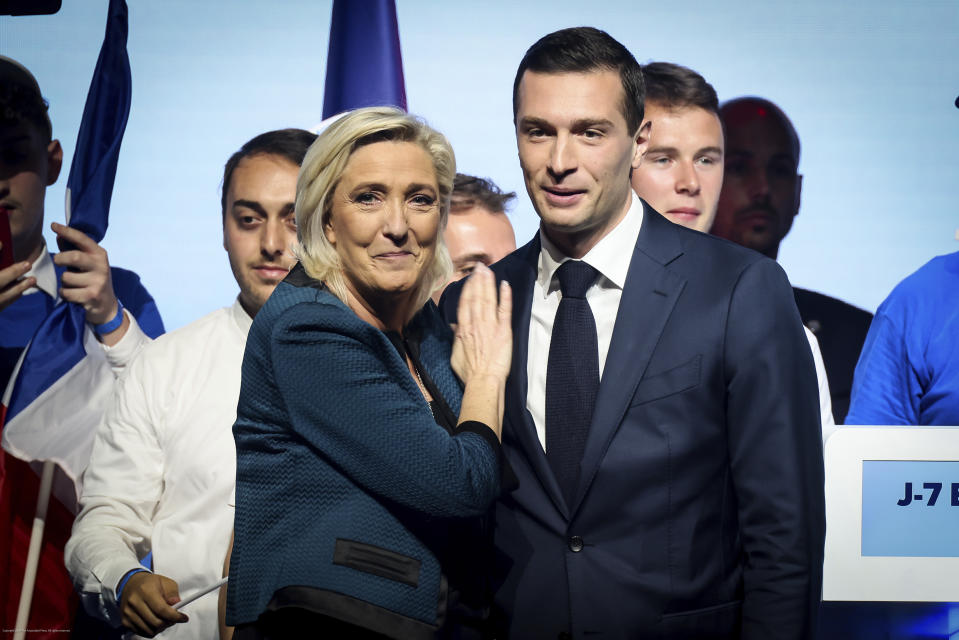 FILE - Leader of the French far-right National Rally Marine Le Pen, left and lead candidate of the party for the upcoming European election Jordan Bardella during a political meeting on June 2, 2024 in Paris. France's far-right leader has contradicted the country's constitution when she raised the question of who would be in charge of the military if her hostile National Rally takes over the government after the election. (AP Photo/Thomas Padilla, File)