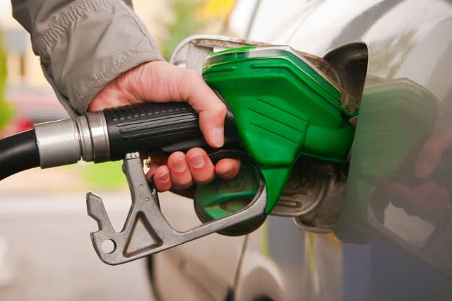 male hand refilling the car with fuel on a filling station