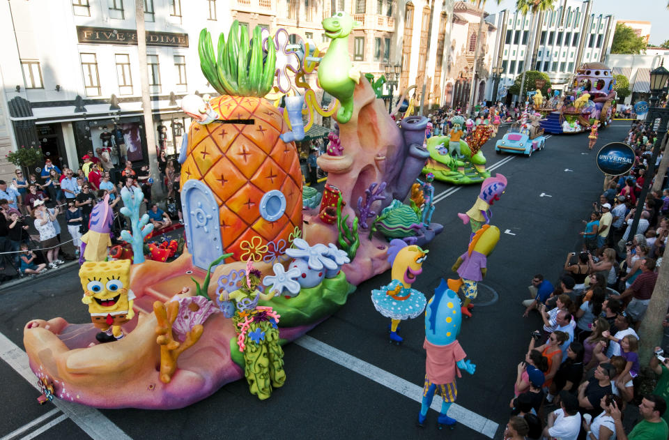 In this May 2012 photo released by Universal Orlando Resort, characters from Nickelodeon's "SpongeBob SquarePants" program are shown during the new Superstar Parade at Universal Orlando in Orlando, Fla. The attraction offers floats with hundreds of performers and characters from animated films and TV shows including "Despicable Me," "Hop," Nickelodeon’s "SpongeBob SquarePants" and "Dora & Diego." The parade, which debuted in early May, is one of a number of new attractions at theme parks around the country this season.  (AP Photo/Universal Orlando Resport, Ed Hall)