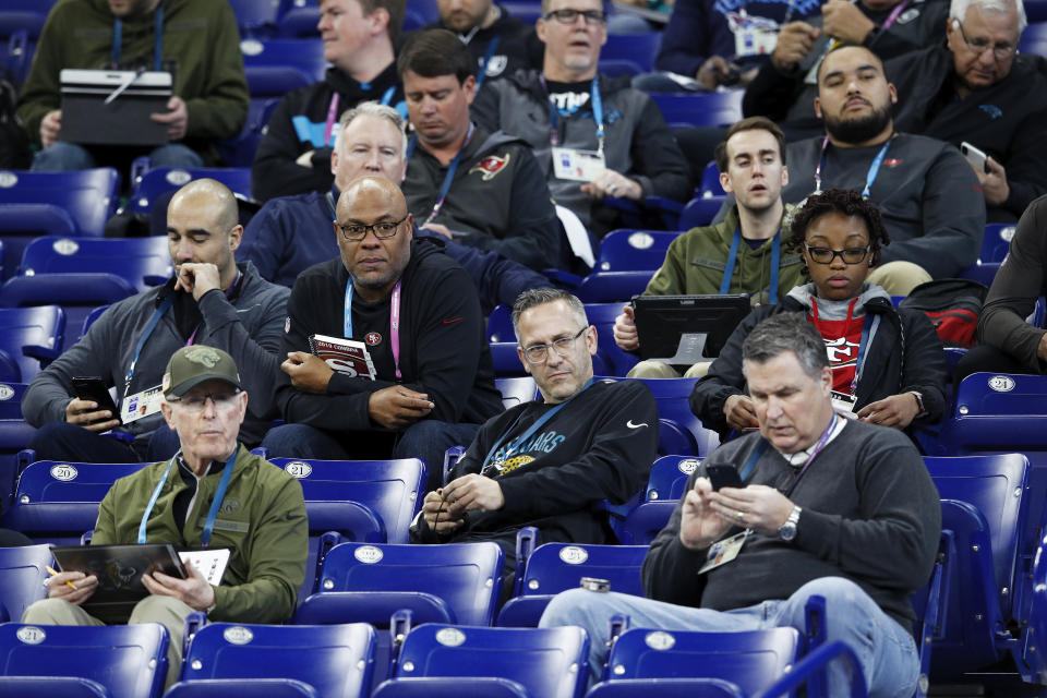 A group of coaches and scouts from various NFL teams observe the action during the NFL Combine at Lucas Oil Stadium in 2019. If there is a combine in 2021, prospects' workout numbers, testing and even positional drills there likely will carry extra weight in draft evaluations. (Joe Robbins/Getty Images)