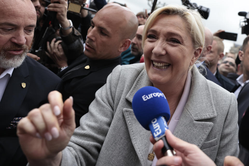 French far-right leader Marine Le Pen smiles as she arrives for a campaign stop Monday, April 18, 2022 in Saint-Pierre-en-Auge, Normandy. French President Emmanuel Macron is facing off against far-right challenger Marine Le Pen in France's April 24 presidential runoff. (AP Photo/Jeremias Gonzalez)