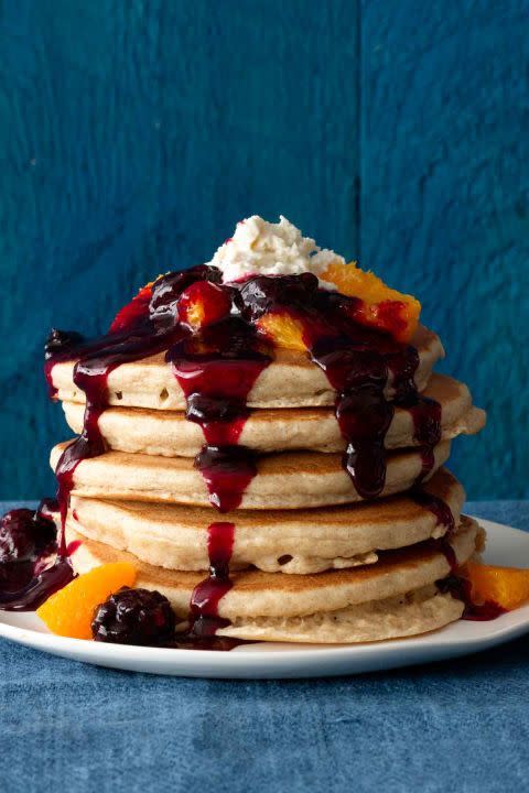 breakfast in bed stack of ricotta pancakes with blackberry orange syrup