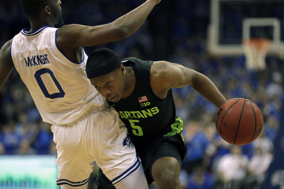 Michigan State guard Cassius Winston (5) is called for a foul against Seton Hall guard Quincy McKnight during the first half of an NCAA college basketball game Thursday, Nov. 14, 2019, in Newark, N.J. (AP Photo/Adam Hunger)