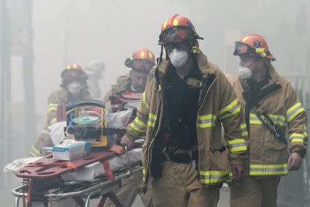 New York City Fire Department firefighters respond to a fire at the site of a residential apartment building collapse and fire in New York City's East Village neighborhood, March 26, 2015. REUTERS/Brendan McDermid