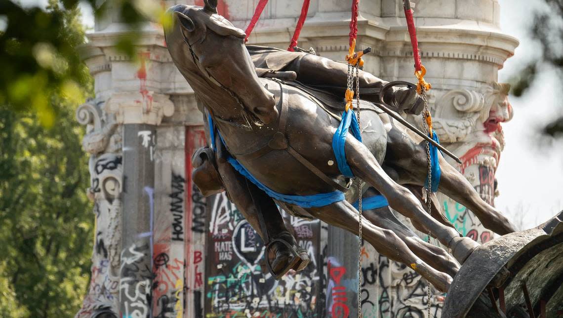 The statue of Robert E. Lee, the Confederate general who fought in defense of slavery, is removed from its pedestal in Richmond, Virginia.