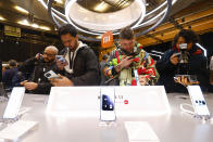 Visitors take pictures of Xiaomi 13 mobile phone models at the Xiaomi booth before the Mobile World Congress 2023 in Barcelona, Spain, on Sunday, Feb. 26, 2023. The four-day show, also known as Mobile World Congress, kicks off Monday in a vast Barcelona conference center. It's the world's biggest and most influential meeting for the mobile tech industry. (AP Photo/Joan Monfort)