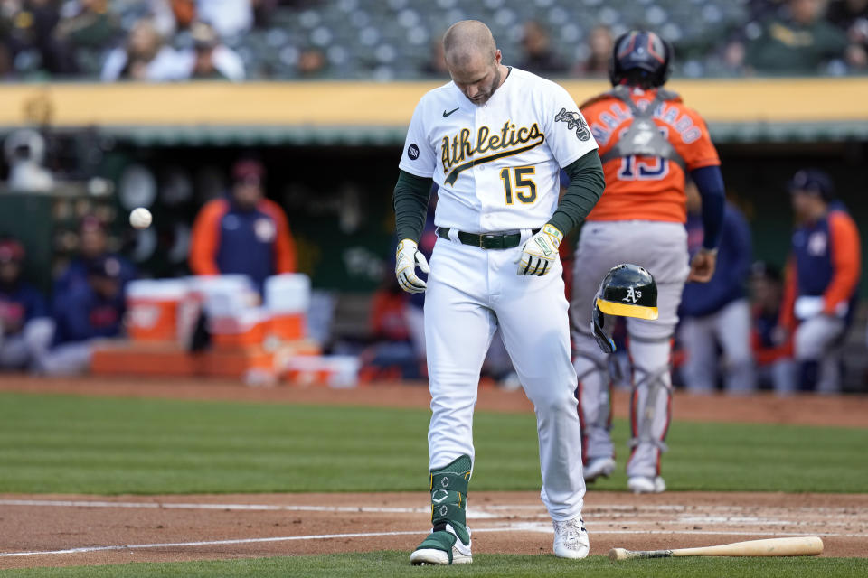 Oakland Athletics' Seth Brown, foreground, reacts after striking out against the Houston Astros during the first inning of a baseball game in Oakland, Calif., Friday, May 26, 2023. (AP Photo/Godofredo A. Vásquez)
