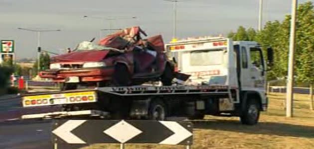 The wreckage of the car is towed from the scene. Photo: 7News