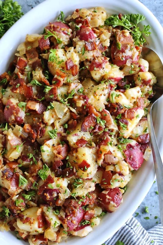 <p>A Farm Girl's Dabbles</p><p>This warm German potato salad recipe features tender red potatoes and bites of bacon in a tangy bacon, vinegar and mustard dressing. It’s a family favorite that we enjoy all year long!</p><p><strong>Get the recipe: <a href="https://www.afarmgirlsdabbles.com/german-potato-salad-recipe/" rel="nofollow noopener" target="_blank" data-ylk="slk:Warm German Potato Salad;elm:context_link;itc:0;sec:content-canvas" class="link ">Warm German Potato Salad</a></strong></p>